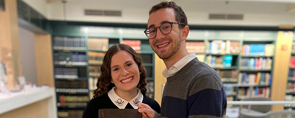 She loves Jewish literature. He loves her. So he proposed in a Yiddish library.